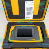Technician using Fluke ii900 acoustic imaging camera in manufacturing facility