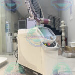 Bison Lucid Q-PTP Laser System with touchscreen interface and articulated laser arm for pigmentation and tattoo removal treatments.