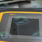 Industrial maintenance engineer inspecting machinery with Fluke ii910