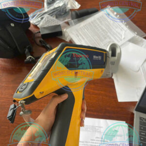 Technician using Niton XL2 100G handheld XRF analyzer for positive material identification