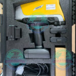 Olympus Vanta Max portable XRF analyzer performing alloy identification on stainless steel pipe