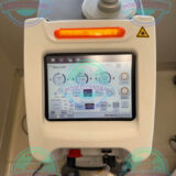 DEKA SmartXide DOT CO₂ laser system installed in a modern dermatology clinic.